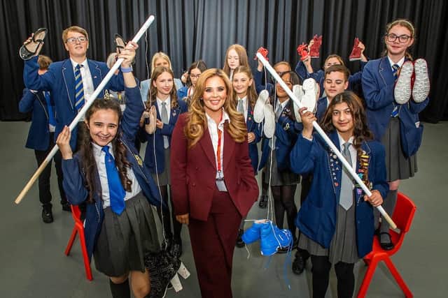 Students and members of the Children's Charity with founder Rebecca Jane, Chief Executive Officer of private mental health clinic RJ8, prepare to launch their 120 shoes display to raise awareness of suicide rates