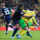 NORWICH, ENGLAND - APRIL 10: Milot Rashica of Norwich City is challenged by Matthew Lowton of Burnley during the Premier League match between Norwich City and Burnley at Carrow Road on April 10, 2022 in Norwich, England. (Photo by Stephen Pond/Getty Images)