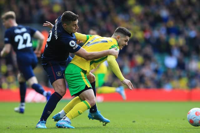 NORWICH, ENGLAND - APRIL 10: Milot Rashica of Norwich City is challenged by Matthew Lowton of Burnley during the Premier League match between Norwich City and Burnley at Carrow Road on April 10, 2022 in Norwich, England. (Photo by Stephen Pond/Getty Images)
