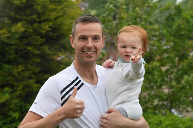 Postman Chris Bibby pictured with his daughter Eden, aged one  Photo: Neil Cross