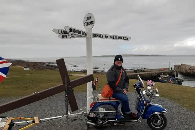 Rev. Phil Ingram on his Vespa scooter at John O'Groats before setting off to Land's End
