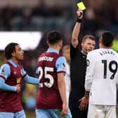 BURNLEY, ENGLAND - NOVEMBER 25: Referee Samuel Barrott shows a yellow card to Edson Alvarez of West Ham United during the Premier League match between Burnley FC and West Ham United at Turf Moor on November 25, 2023 in Burnley, England. (Photo by Matt McNulty/Getty Images)
