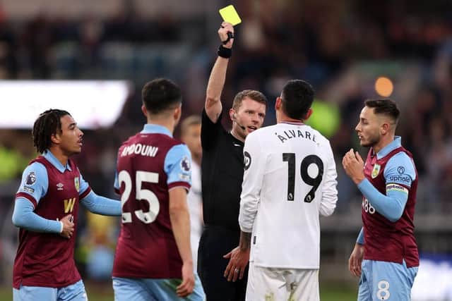 BURNLEY, ENGLAND - NOVEMBER 25: Referee Samuel Barrott shows a yellow card to Edson Alvarez of West Ham United during the Premier League match between Burnley FC and West Ham United at Turf Moor on November 25, 2023 in Burnley, England. (Photo by Matt McNulty/Getty Images)