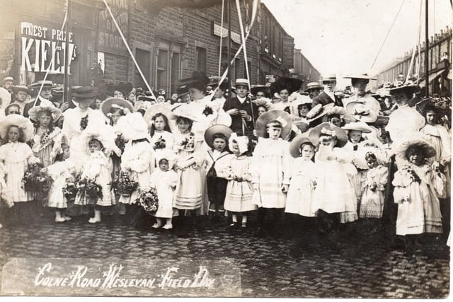 Taken on Abel Street, about 1906, this image shows children enjoying the procession which preceded Colne Road Wesleyan Chapel’s Field Day