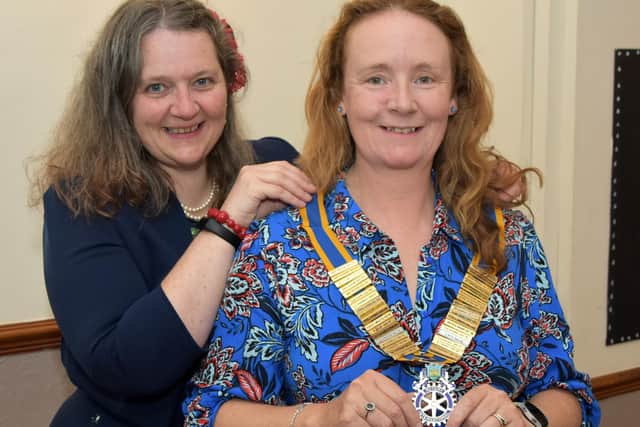 Retiring Clitheroe Rotary Club president Jenni Schumann hands over her chain of office to incoming president Karin Wilson