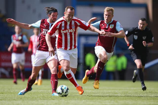 BURNLEY, ENGLAND - MAY 16: Charlie Adam (C) of Stoke City competes against George Boyd (L) and Scott Arfield (R) of Burnley during the Barclays Premier League match between Burnley and Stoke City at Turf Moor on May 16, 2015 in Burnley, England.  (Photo by Jan Kruger/Getty Images)