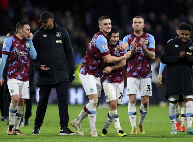 BURNLEY, ENGLAND - DECEMBER 27: Taylor Harwood-Bellis, Josh Cullen and Jordan Beyer of Burnley applaud the fans after their victory in the Sky Bet Championship between Burnley and Birmingham City at Turf Moor on December 27, 2022 in Burnley, England. (Photo by Cameron Smith/Getty Images)