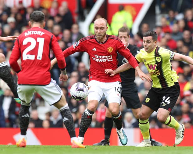 MANCHESTER, ENGLAND - APRIL 27: Christian Eriksen of Manchester United in action with Josh Cullen of Burnley during the Premier League match between Manchester United and Burnley FC at Old Trafford on April 27, 2024 in Manchester, England. (Photo by Matthew Peters/Manchester United via Getty Images)