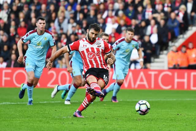 SOUTHAMPTON, ENGLAND - OCTOBER 16:  Charlie Austin of Southampton scores their third goal from the penalty spot during the Premier League match between Southampton and Burnley at St Mary's Stadium on October 16, 2016 in Southampton, England.