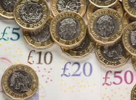 What is the National Living Wage and what is the minimum hourly rate of pay currently in the UK in 2022?
