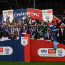 BURNLEY, ENGLAND - MAY 08: Jack Cork and Josh Brownhill of Burnley lift the Sky Bet Championship trophy with teammates after victory against Cardiff City during the Sky Bet Championship between Burnley and Cardiff City at Turf Moor on May 08, 2023 in Burnley, England. (Photo by Gareth Copley/Getty Images)