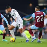 BURNLEY, ENGLAND - NOVEMBER 25: Emerson Palmieri of West Ham United battles for possession with Johann Gudmundsson and Vitinho of Burnley during the Premier League match between Burnley FC and West Ham United at Turf Moor on November 25, 2023 in Burnley, England. (Photo by James Gill/Getty Images)