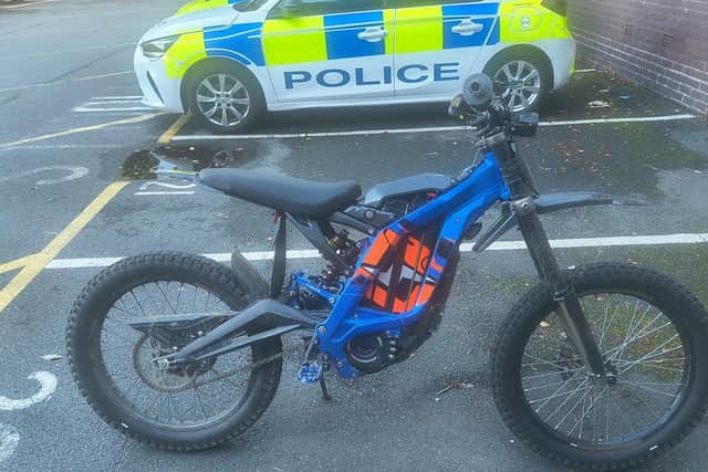 Police offcers seize illegal electric bike being driven on McDonald's ...