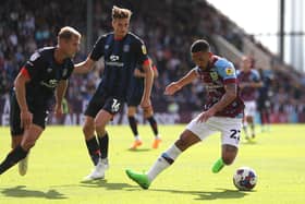 BURNLEY, ENGLAND - AUGUST 06: Vitinho of Burnley FC keeps the ball away from Reece Burke and James Bree of Luton Town during the Sky Bet Championship match between Burnley and Luton Town at Turf Moor on August 06, 2022 in Burnley, England. (Photo by Ashley Allen/Getty Images)