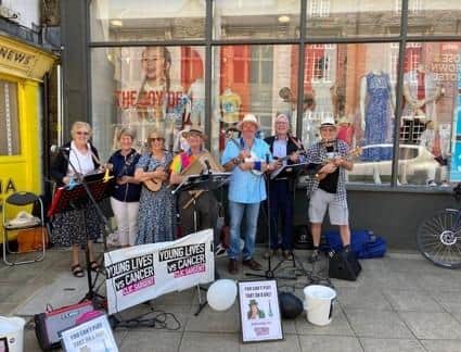 Iris, Jenny, Joan, Tom, Nigel, Charles and Graham performing on their ukuleles in Clitheroe