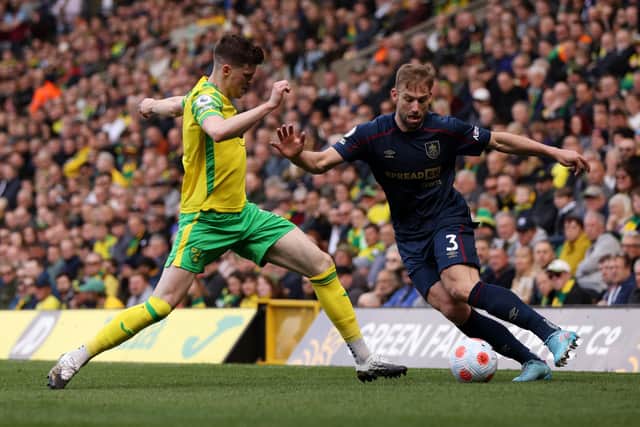 NORWICH, ENGLAND - APRIL 10: Charlie Taylor of Burnley and Sam Byram of Norwich City battle for the ball  during the Premier League match between Norwich City and Burnley at Carrow Road on April 10, 2022 in Norwich, England. (Photo by Paul Harding/Getty Images)