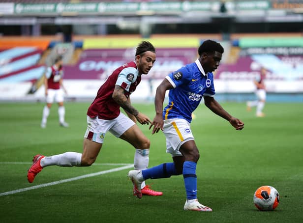 BURNLEY, ENGLAND - JULY 26: Tariq Lamptey of Brighton and Hove Albion and Josh Brownhill of Burnley battle for the ball during the Premier League match between Burnley FC and Brighton & Hove Albion at Turf Moor on July 26, 2020 in Burnley, England. Football Stadiums around Europe remain empty due to the Coronavirus Pandemic as Government social distancing laws prohibit fans inside venues resulting in all fixtures being played behind closed doors. (Photo by Richard Heathcote/Getty Images)