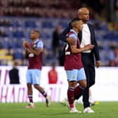 BURNLEY, ENGLAND - AUGUST 11: Vitinho of Burnley is consoled by Head Coach Vincent Kompany after the team's defeat in the Premier League match between Burnley FC and Manchester City at Turf Moor on August 11, 2023 in Burnley, England. (Photo by Nathan Stirk/Getty Images)