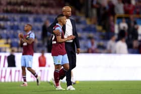 BURNLEY, ENGLAND - AUGUST 11: Vitinho of Burnley is consoled by Head Coach Vincent Kompany after the team's defeat in the Premier League match between Burnley FC and Manchester City at Turf Moor on August 11, 2023 in Burnley, England. (Photo by Nathan Stirk/Getty Images)