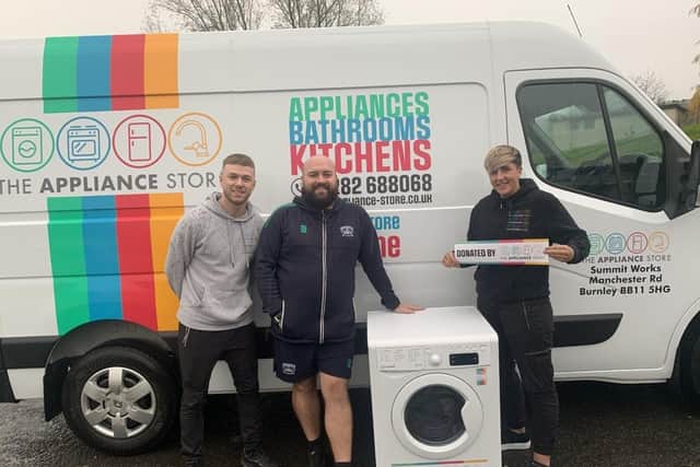 Jordan Coates (centre) a teacher at Springfield Community Primary School, takes receipt of the washing machine from The Appliance Store’s staff, Josh Baldwin and Melissa Jarvis.