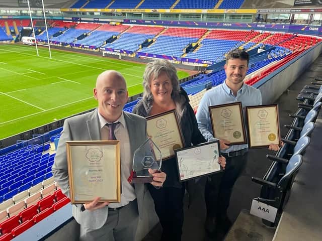 Andrew Dean, of Burnley BID (left) with Debbie Hernon, of Charter Walk, and Bryn Davies, of Burnley Council's greenspaces team, with the awards after a ceremony at Bolton Stadium