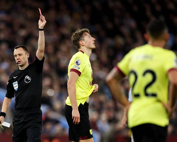 BIRMINGHAM, ENGLAND - DECEMBER 30: Sander Berge of Burnley is shown a red card by Referee Stuart Attwell during the Premier League match between Aston Villa and Burnley FC at Villa Park on December 30, 2023 in Birmingham, England. (Photo by Richard Heathcote/Getty Images)