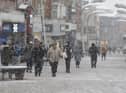 Shoppers in Blackpool bracing the snow during Storm Eunice in February 2022