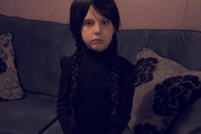 Chloe (seven) is dressed as Wednesday Addams.