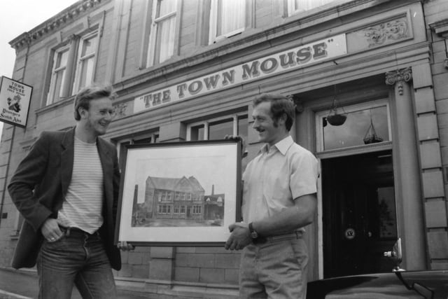 Craig Simpson , left, and John Kaye outside the Town Mouse, with Craig’s painting of the pub.
A new painting has been added to the many already on the walls of the Town Mouse, a water colour of the pub by 20 year-old Burnley artist, Craig Simpson, which had been commissioned by Town Mouse partner, John Kaye, to complement one they already had, but from a different view point.