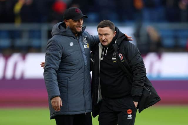 BURNLEY, ENGLAND - DECEMBER 02: Vincent Kompany, Manager of Burnley, and Paul Heckingbottom, Manager of Sheffield United, interact prior to the Premier League match between Burnley FC and Sheffield United at Turf Moor on December 02, 2023 in Burnley, England. (Photo by Nathan Stirk/Getty Images)