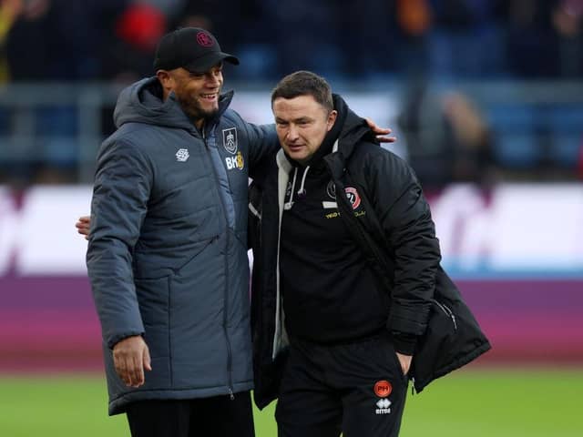 BURNLEY, ENGLAND - DECEMBER 02: Vincent Kompany, Manager of Burnley, and Paul Heckingbottom, Manager of Sheffield United, interact prior to the Premier League match between Burnley FC and Sheffield United at Turf Moor on December 02, 2023 in Burnley, England. (Photo by Nathan Stirk/Getty Images)
