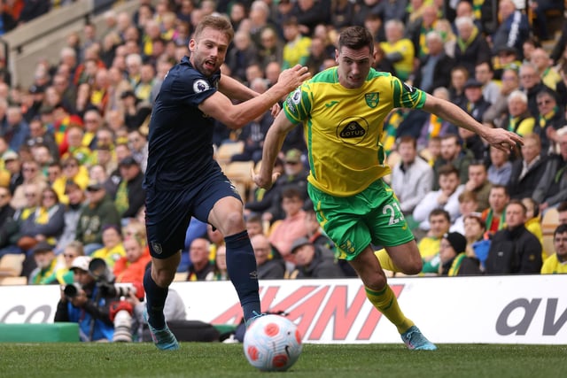 NORWICH, ENGLAND - APRIL 10: Charlie Taylor of Burnley battles for possession with Kenny McLean of Norwich City during the Premier League match between Norwich City and Burnley at Carrow Road on April 10, 2022 in Norwich, England. (Photo by Paul Harding/Getty Images)
