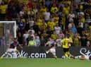 WATFORD, ENGLAND - AUGUST 12: Tom Cleverley of Watford scores their side's first goal whilst under pressure from Josh Cullen and Josh Brownhill of Burnley during the Sky Bet Championship between Watford and Burnley at Vicarage Road on August 12, 2022 in Watford, England. (Photo by Richard Heathcote/Getty Images)