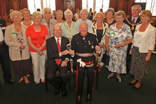 Staff and volunteers at Pendleside Hospice celebrating after being awarded the Queen's Award for Voluntary Service.