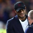 Burnley's Belgian manager Vincent Kompany (L) shakes hands with Nottingham Forest's Welsh manager Steve Cooper (R) ahead of kick-off in the English Premier League football match between Nottingham Forest and Burnley at The City Ground in Nottingham, central England, on September 18, 2023. (Photo by Darren Staples / AFP) /