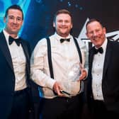 CoolKit managing director Daniel Miller, centre, receives the TCS&D Refrigerated Panel Van Of The Year award from Simon Ragless, chief executive officer of sponsors Commercial Body Fittings Production Division, left, watched by host and comedian Lea Roberts.
