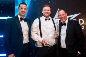 CoolKit managing director Daniel Miller, centre, receives the TCS&D Refrigerated Panel Van Of The Year award from Simon Ragless, chief executive officer of sponsors Commercial Body Fittings Production Division, left, watched by host and comedian Lea Roberts.