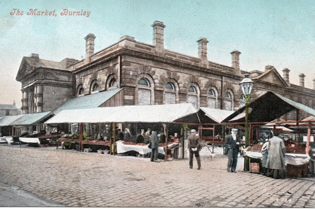 An early postcard view of Burnley Market Hall and Market Square. Notice the gas lamp, right, and the spire of St James the Great, left