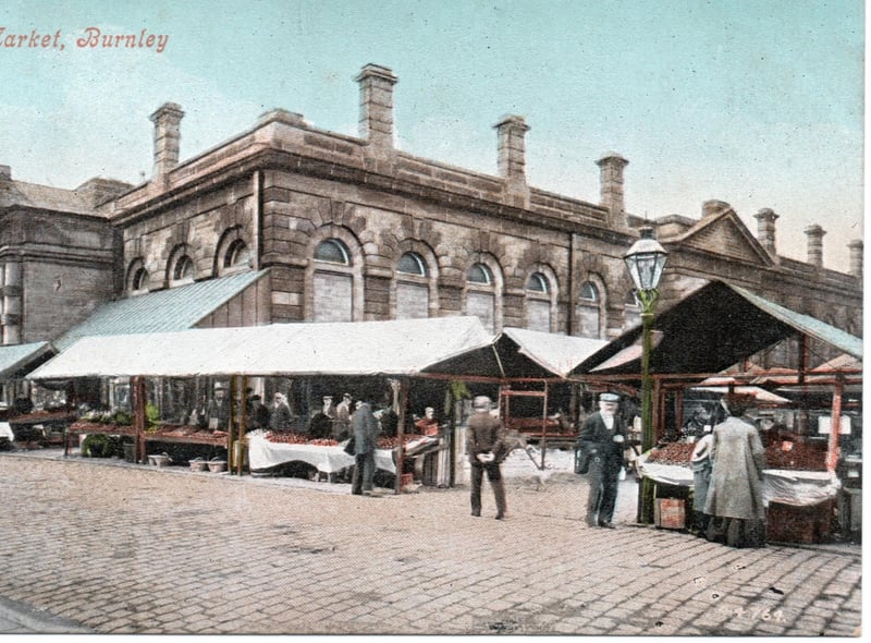 An early postcard view of Burnley Market Hall and Market Square. Notice the gas lamp, right, and the spire of St James the Great, left