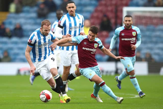 BURNLEY, ENGLAND - JANUARY 08: Jordan Rhodes of Huddersfield Town battles for possession with Ashley Westwood of Burnley during the Emirates FA Cup Third Round match between Burnley and Huddersfield Town at Turf Moor on January 08, 2022 in Burnley, England. (Photo by Jan Kruger/Getty Images)