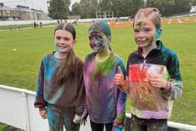 These three pals are still smiling after taking part in a very wet colour run