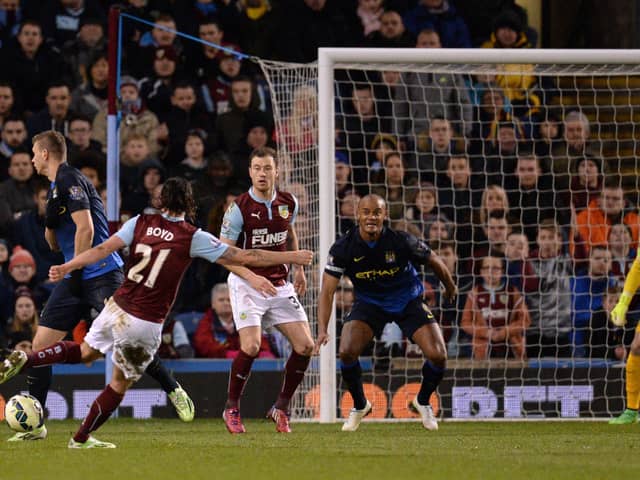 Burnley's Scottish midfielder George Boyd (L) shoots to score the opening goal of the English Premier League football match between Burnley and Manchester City at Turf Moor in Burnley, north west England, on March 14, 2015. AFP PHOTO / OLI SCARFF

RESTRICTED TO EDITORIAL USE. No use with unauthorized audio, video, data, fixture lists, club/league logos or live services. Online in-match use limited to 45 images, no video emulation. No use in betting, games or single club/league/player publications.        (Photo credit should read OLI SCARFF/AFP via Getty Images)