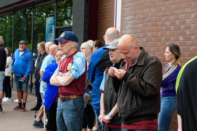 Crowds gather on Harry Potts Way outside Turf Moor to pay their respects to Derek 'Rocky' Mills. Photo: Kelvin Stuttard