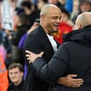 MANCHESTER, ENGLAND - MARCH 18: Vincent Kompany, Manager of Burnley, embraces Pep Guardiola, Manager of Manchester City, prior to the Emirates FA Cup Quarter Final match between Manchester City and Burnley at Etihad Stadium on March 18, 2023 in Manchester, England. (Photo by Michael Regan/Getty Images)