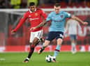 Manchester United's English striker Marcus Rashford (L) fights for the ball with Burnley's German defender Jordan Beyer during the English League Cup fourth round football match between Manchester United and Burnley, at Old Trafford, in Manchester, on December 21, 2022.