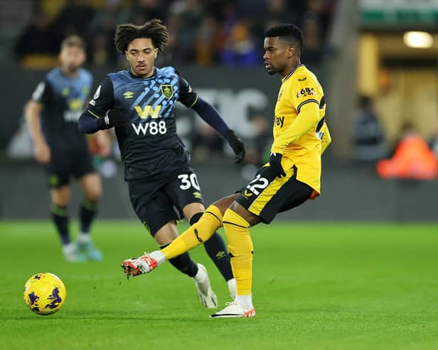 WOLVERHAMPTON, ENGLAND - DECEMBER 05: Nelson Semedo of Wolverhampton Wanderers passes the ball whilst under pressure from Luca Koleosho of Burnley during the Premier League match between Wolverhampton Wanderers and Burnley FC at Molineux on December 05, 2023 in Wolverhampton, England. (Photo by David Rogers/Getty Images)