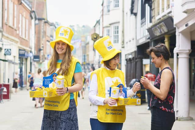 Volunteers collecting for the Great Daffodil Appeal 2018 in Winchester. The person donating is Miriam Strong. Credit: Ben Gold
