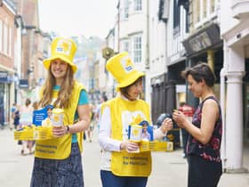 Volunteers collecting for the Great Daffodil Appeal 2018 in Winchester. The person donating is Miriam Strong. Credit: Ben Gold