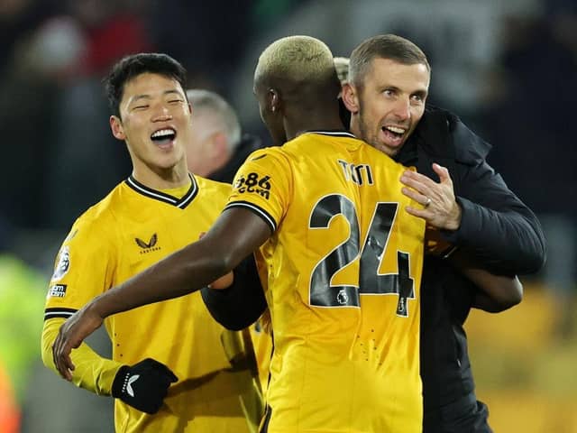 WOLVERHAMPTON, ENGLAND - DECEMBER 05: Gary O'Neil, Manager of Wolverhampton Wanderers, celebrates with Toti Gomes and Hwang Hee-Chan of Wolverhampton Wanderers following the team's victory during the Premier League match between Wolverhampton Wanderers and Burnley FC at Molineux on December 05, 2023 in Wolverhampton, England. (Photo by David Rogers/Getty Images)