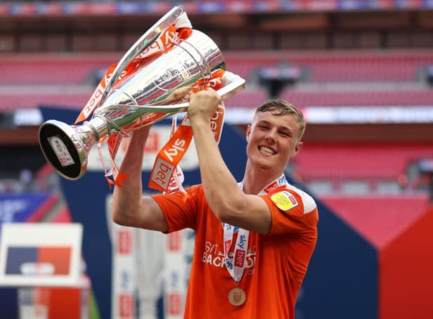 LONDON, ENGLAND - MAY 30: Daniel Ballard of Blackpool  celebrates with the trophy after winning the Sky Bet League One Play-off Final match between Blackpool and Lincoln City at Wembley Stadium on May 30, 2021 in London, England. A limited number of fans will be allowed into the stadium as Coronavirus restrictions begin to ease in the UK following the COVID-19 pandemic. (Photo by Catherine Ivill/Getty Images)